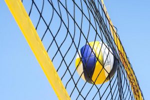 Beach volleyball caught in the net.